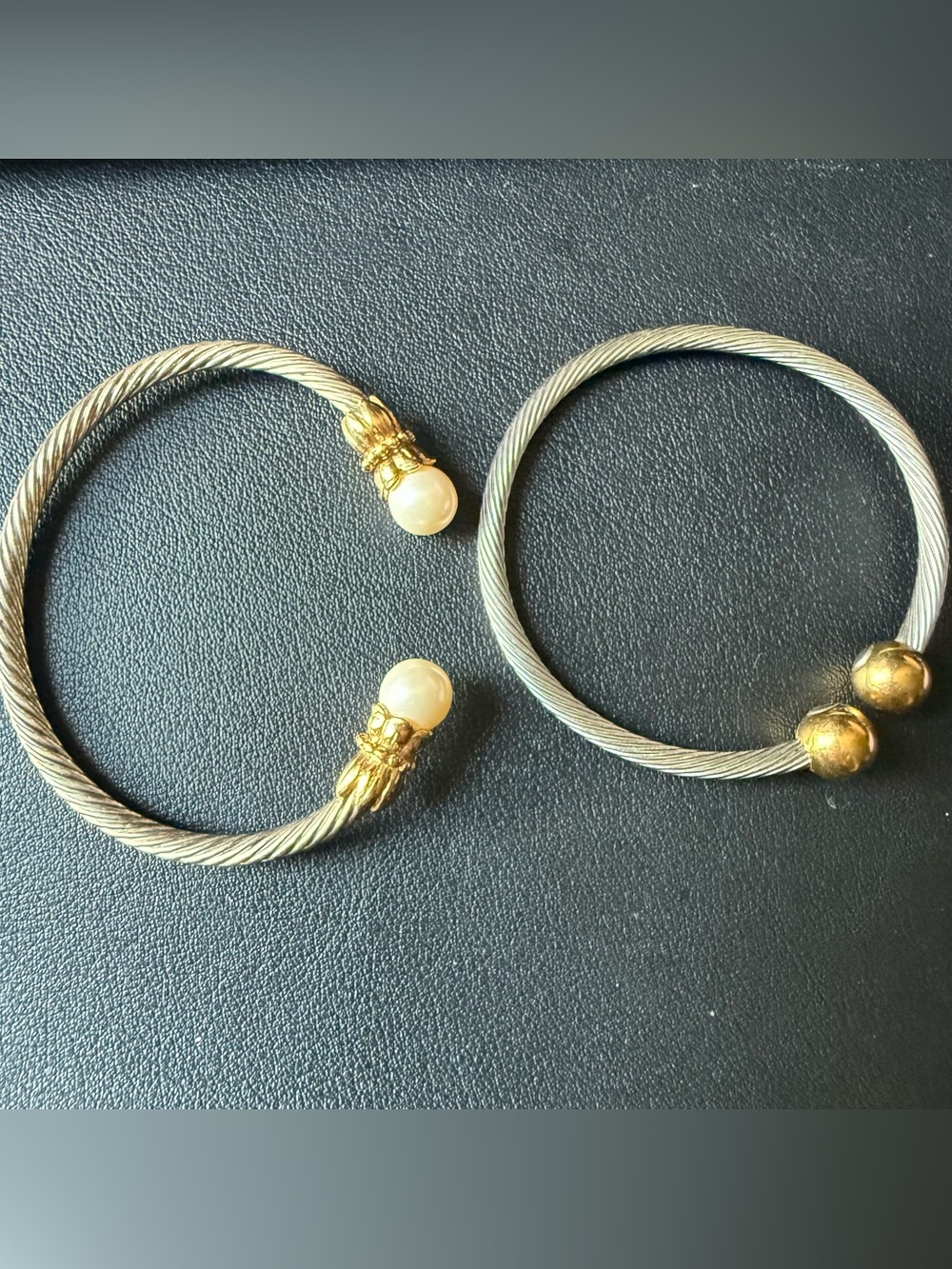 2 Bracelets Twisted Cuffs Silver and Gold Tones - 1 has the magnets inside